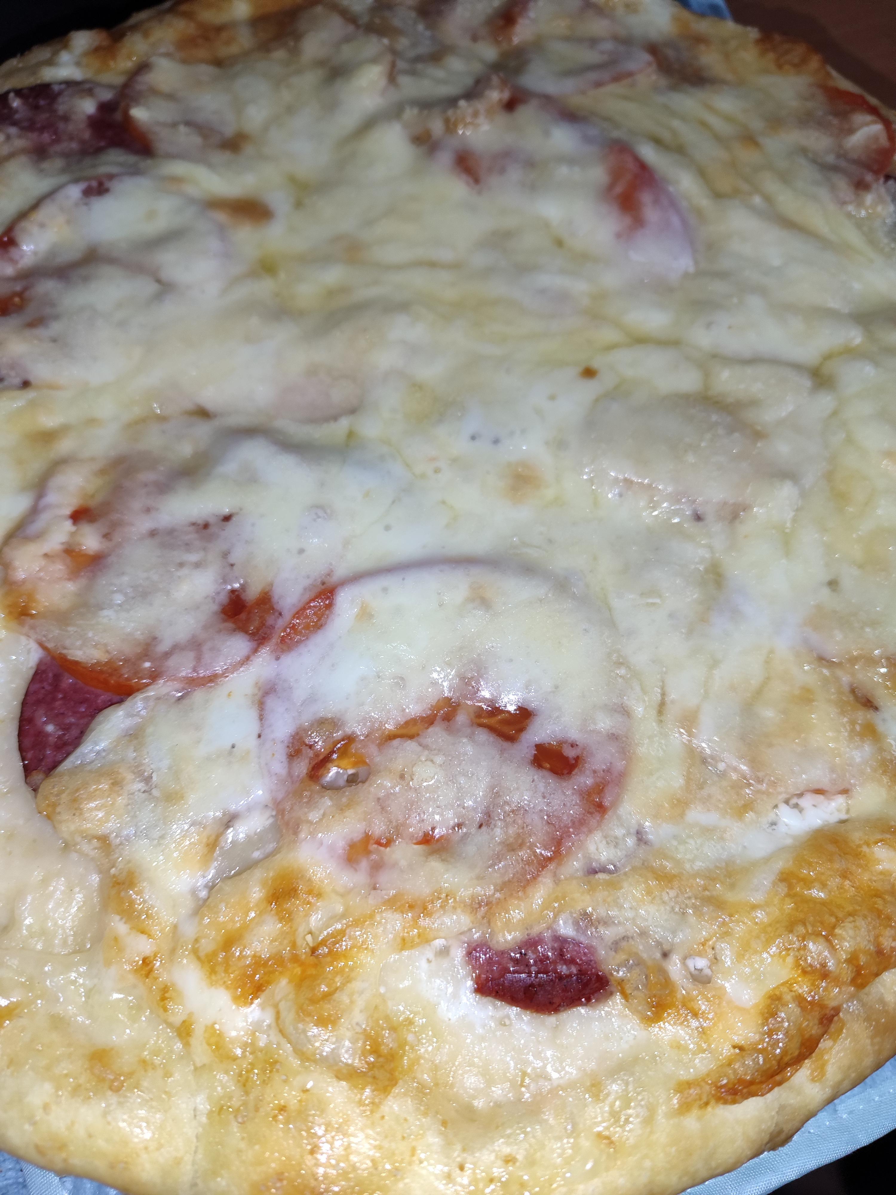 Піца з ковбасою, куркою, томатами та пармезаном