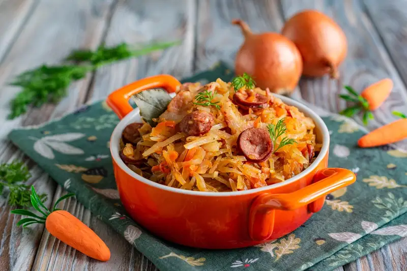 Stewed cabbage with smoked brisket and hunting sausages in a multicooker