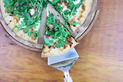 white pizza with roasted garlic, prosciutto, and arugula